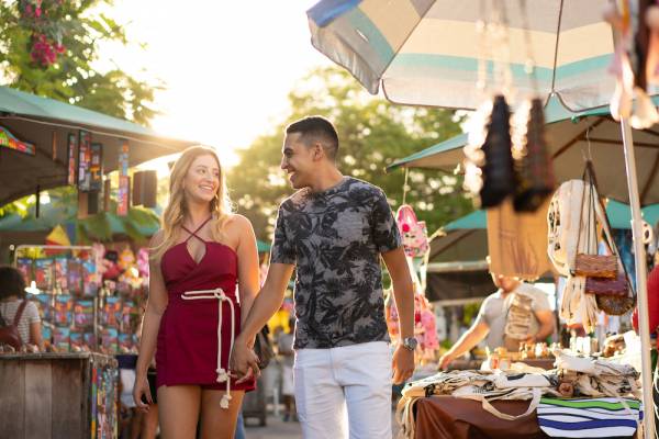couple strolling outdoor vendor stalls