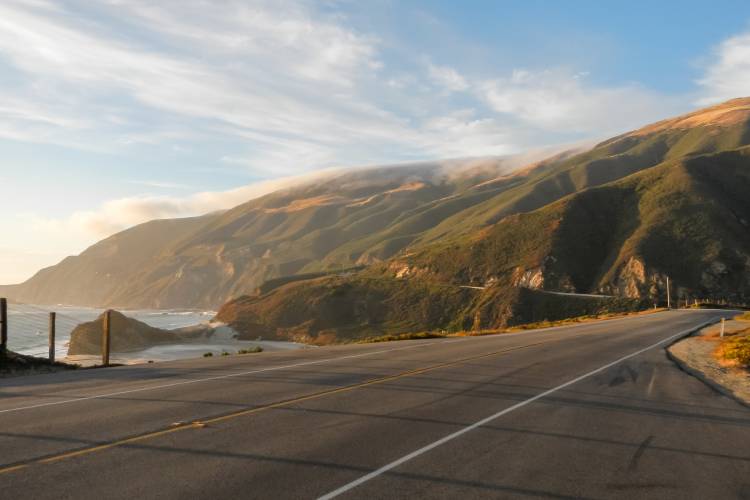 The sun making hills on the Scenic highway 1 glow with golden light