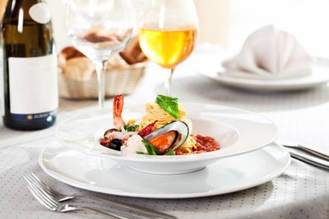 A fine dining table with fresh seafood and wine