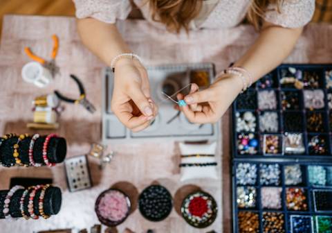 aerial view of woman making jewelry
